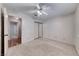 Bedroom features neutral carpet, a sliding closet, a ceiling fan and an adjoining door at 729 Scottsdale St, Henderson, NV 89002