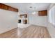 Open dining area with hardwood floors, vintage chandelier, and adjacent kitchen access at 729 Scottsdale St, Henderson, NV 89002