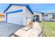 Front exterior featuring an attached two-car garage and gated front yard with xeriscaping at 729 Scottsdale St, Henderson, NV 89002