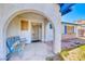 Inviting front porch with a decorative bench, arched entryways, and tiled patio at 729 Scottsdale St, Henderson, NV 89002