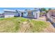 Charming single-story home with a xeriscaped front yard, secure gate and blue trim at 729 Scottsdale St, Henderson, NV 89002