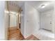 Bright hallway with hardwood floors and white tile, leading to various rooms at 729 Scottsdale St, Henderson, NV 89002