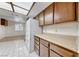 Bright kitchen featuring wood cabinets and laminate countertops next to a large living area at 729 Scottsdale St, Henderson, NV 89002