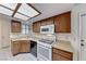 Well-lit kitchen features wood cabinets, laminate countertops, and white appliances at 729 Scottsdale St, Henderson, NV 89002