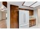 Spacious kitchen area with white refrigerator, oak cabinets, and laminate countertops at 729 Scottsdale St, Henderson, NV 89002