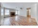 Bright living room featuring hardwood floors, a brick fireplace, and large windows at 729 Scottsdale St, Henderson, NV 89002