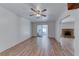 Spacious living room with wood-look floors, ceiling fan and sliding doors to patio and adjoining fireplace room at 729 Scottsdale St, Henderson, NV 89002