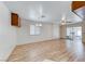 Open living room with wood floors, fan and lighting, adjacent to a sunroom with exercise equipment at 729 Scottsdale St, Henderson, NV 89002
