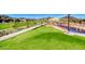 Scenic park view with lush green grass, trees, walking path, and colorful playground equipment at 729 Scottsdale St, Henderson, NV 89002