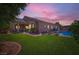 Expansive backyard with a well-maintained lawn, covered patio area, ideal for outdoor entertaining, and a private pool at 7418 Lawrence Powers Ct, Las Vegas, NV 89129
