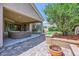 Serene backyard with a covered patio, lush landscaping, and a cozy fire pit area at 7418 Lawrence Powers Ct, Las Vegas, NV 89129