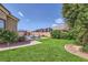 Expansive backyard showcasing lush greenery, mature trees, and meticulous landscaping, offering privacy at 7418 Lawrence Powers Ct, Las Vegas, NV 89129