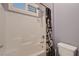 The bathroom has a bathtub and shower with a shower curtain and window at 7418 Lawrence Powers Ct, Las Vegas, NV 89129