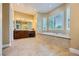 Bright bathroom featuring a soaking tub, spacious vanity, and neutral tile flooring at 7418 Lawrence Powers Ct, Las Vegas, NV 89129