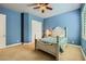 Comfortable bedroom features neutral carpet, bright windows, and an overhead fan at 7418 Lawrence Powers Ct, Las Vegas, NV 89129