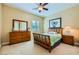 This bedroom has warm colors, carpet, and a window with plantation shutters, great for a or guest at 7418 Lawrence Powers Ct, Las Vegas, NV 89129