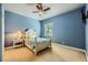 Charming bedroom features a ceiling fan, neutral carpet, and a bright window at 7418 Lawrence Powers Ct, Las Vegas, NV 89129