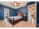 Well-lit bedroom boasting blue walls, carpet flooring, and a view into the en-suite bathroom at 7418 Lawrence Powers Ct, Las Vegas, NV 89129