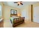 Cozy bedroom with a wooden bed frame, carpet flooring, and a ceiling fan for a comfortable space at 7418 Lawrence Powers Ct, Las Vegas, NV 89129