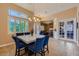 Open dining area with a modern table set, shuttered windows, and seamless access to other living spaces at 7418 Lawrence Powers Ct, Las Vegas, NV 89129