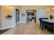 Dining room with tiled floors, blue chairs, and an open floor plan leading to the living room at 7418 Lawrence Powers Ct, Las Vegas, NV 89129