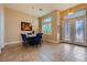 Inviting dining area with decorative windows and a modern table with blue upholstered chairs at 7418 Lawrence Powers Ct, Las Vegas, NV 89129