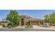Charming single-story home featuring a three-car garage, brick-paved driveway, and a welcoming stone facade at 7418 Lawrence Powers Ct, Las Vegas, NV 89129