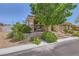 Attractive single-story home featuring a three-car garage, brick-paved driveway, and a welcoming stone facade at 7418 Lawrence Powers Ct, Las Vegas, NV 89129