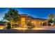 Inviting single-story home showcasing a three-car garage, manicured landscaping, and a charming stone facade at 7418 Lawrence Powers Ct, Las Vegas, NV 89129