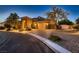 Inviting single-story home showcasing a three-car garage, brick-paved driveway, and a charming stone facade at 7418 Lawrence Powers Ct, Las Vegas, NV 89129
