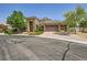 Stunning single-Gathering home displaying desert landscaping, a bench swing, and a three-car garage at 7418 Lawrence Powers Ct, Las Vegas, NV 89129