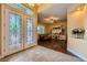 Light-filled foyer featuring decorative glass doors and tile flooring, leading to a cozy living area at 7418 Lawrence Powers Ct, Las Vegas, NV 89129