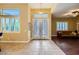 Inviting foyer with decorative glass double doors, tile flooring, and bright windows at 7418 Lawrence Powers Ct, Las Vegas, NV 89129