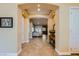 Hallway featuring tile floors, archways, and a view of the living room and backyard at 7418 Lawrence Powers Ct, Las Vegas, NV 89129