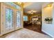 Elegant foyer featuring decorative glass double doors leading to a spacious living area at 7418 Lawrence Powers Ct, Las Vegas, NV 89129