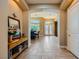 Hallway view with tile floors and decorative archways, leading to a dining room and the front door at 7418 Lawrence Powers Ct, Las Vegas, NV 89129