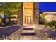 Elegant front entrance with double doors, stone accents, and inviting brick walkway, creating curb appeal at 7418 Lawrence Powers Ct, Las Vegas, NV 89129