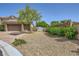 Home exterior with a two-car garage, desert landscaping and a white storage shed at 7418 Lawrence Powers Ct, Las Vegas, NV 89129