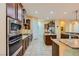 Modern kitchen featuring stainless steel appliances, granite countertops, and ample cabinet space for storage at 7418 Lawrence Powers Ct, Las Vegas, NV 89129