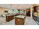 Spacious kitchen featuring granite countertops, stainless steel appliances, and a central island with ample seating at 7418 Lawrence Powers Ct, Las Vegas, NV 89129