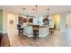 Open kitchen features a breakfast bar with pendant lighting and stainless steel appliances at 7418 Lawrence Powers Ct, Las Vegas, NV 89129