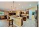 Open kitchen featuring a central island, stainless steel appliances, tile floors, and adjacent Gathering room at 7418 Lawrence Powers Ct, Las Vegas, NV 89129