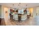 Spacious kitchen with granite countertops, tile floors, stainless appliances, and barstool seating at 7418 Lawrence Powers Ct, Las Vegas, NV 89129