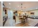 Well-equipped kitchen featuring a center island, breakfast bar, stainless appliances, and adjacent living area at 7418 Lawrence Powers Ct, Las Vegas, NV 89129