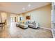 Living room with neutral decor and tile flooring leads to a front entrance with glass double doors at 7418 Lawrence Powers Ct, Las Vegas, NV 89129