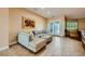 Cozy living room with a plush sofa, tile floors, and access to the outdoor patio at 7418 Lawrence Powers Ct, Las Vegas, NV 89129