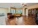 Spacious living room featuring wood floors, plantation shutters, and multiple seating areas at 7418 Lawrence Powers Ct, Las Vegas, NV 89129