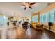 Open-concept living area with wood floors, comfortable seating, and a view of the kitchen at 7418 Lawrence Powers Ct, Las Vegas, NV 89129