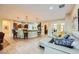 Open-concept living area features tile flooring and a kitchen with a breakfast bar at 7418 Lawrence Powers Ct, Las Vegas, NV 89129