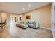 Bright living room with neutral tones, tile flooring, and a comfortable sectional sofa at 7418 Lawrence Powers Ct, Las Vegas, NV 89129